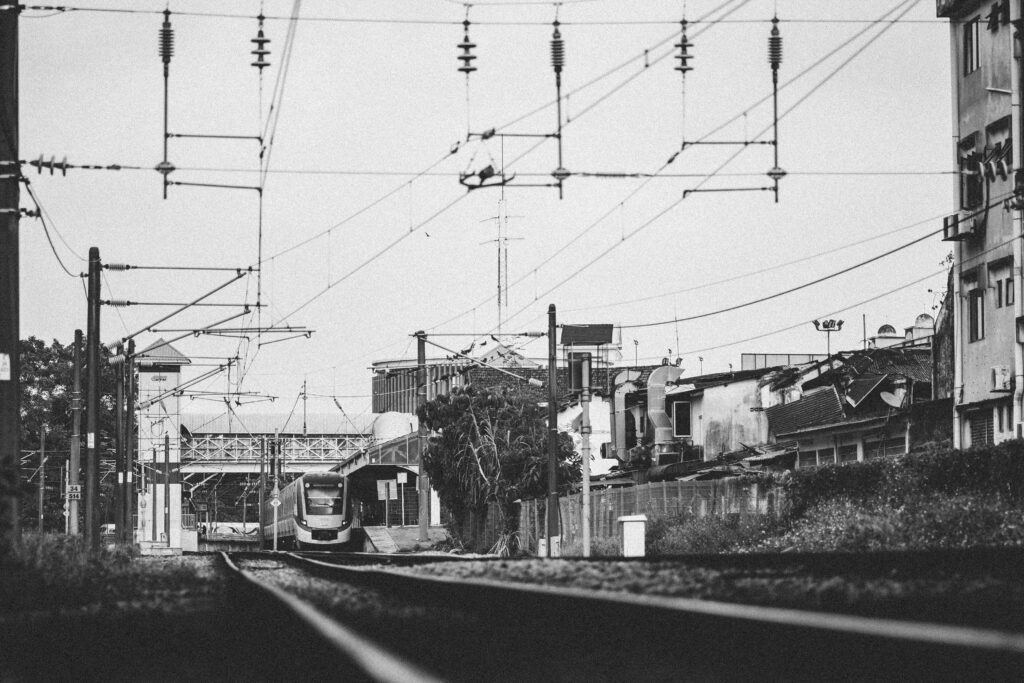 Monochrome view of a train approaching in urban Klang, Malaysia.
