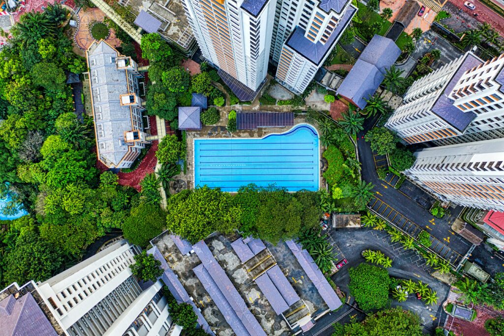 Aerial shot of modern high-rise buildings surrounding a pool in Subang Jaya, Malaysia.